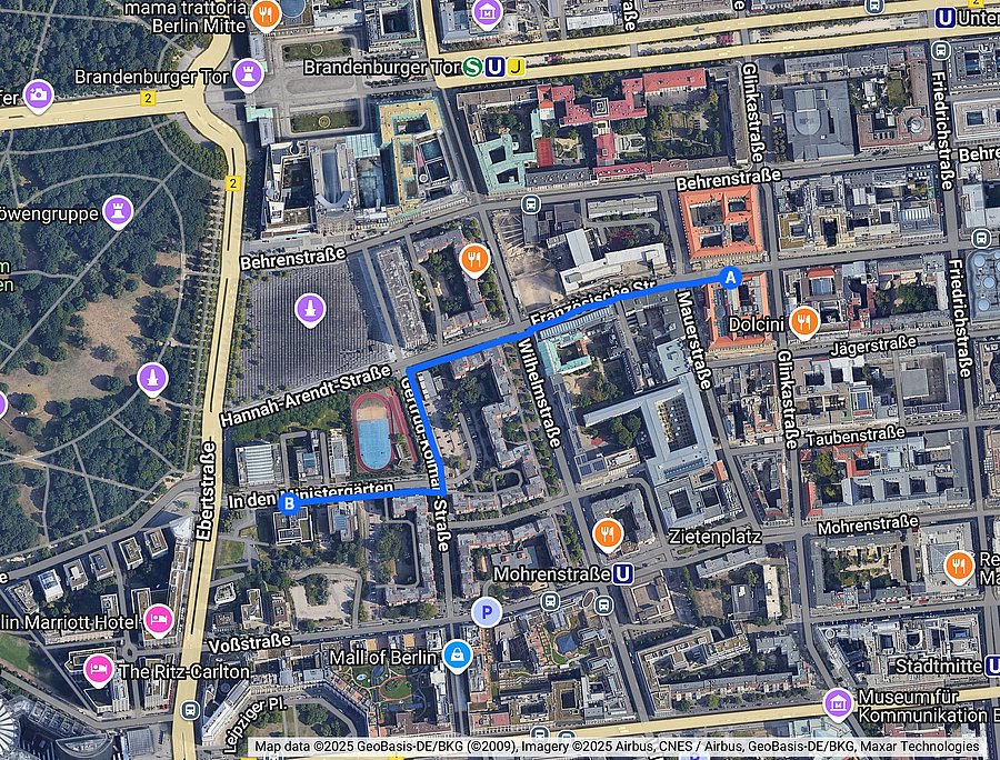A satellite map of the center of Berlin. It contains a route from the Conference Center Mauerstraße (marked A) to the Hessian State Representation (marked B).